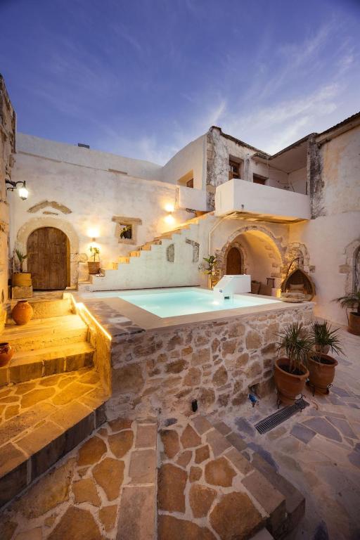a large stone building with a swimming pool at Casa Moro in Episkopi 16km from Rethymno in episkopi-chania