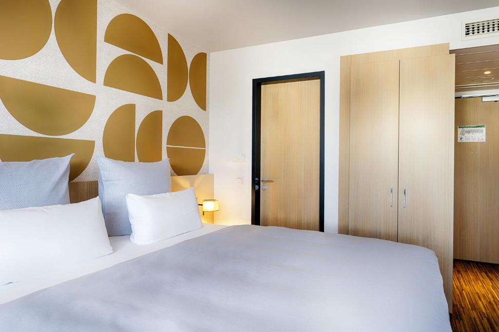 Postel nebo postele na pokoji v ubytování Welcome Hotel Paderborn