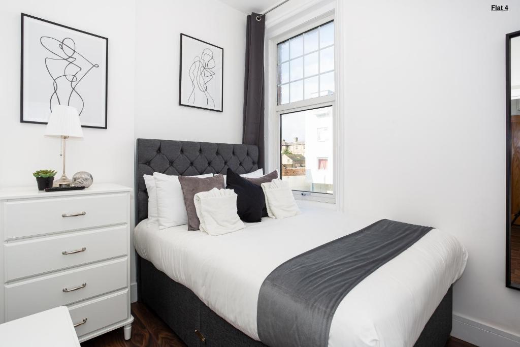 a bedroom with a white bed and a window at 1 Bed Apartments, 2 Mins to Beach, Sleeps 4 in Southend-on-Sea