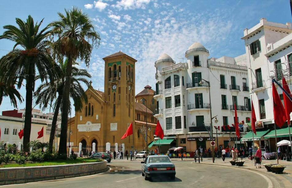 a building with a clock tower in the middle of a street at 2 COZ'S apartments central Medina Tetuan in Tetouan