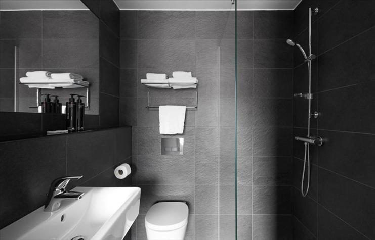 a bathroom with a shower and a toilet and a sink at The Social Hub Eindhoven Extended Stay in Eindhoven