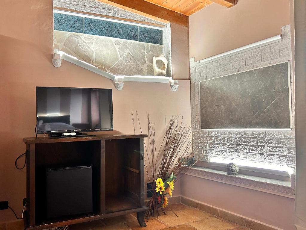 a living room with a tv and a window at Locanda Dei Baroni in Vasto