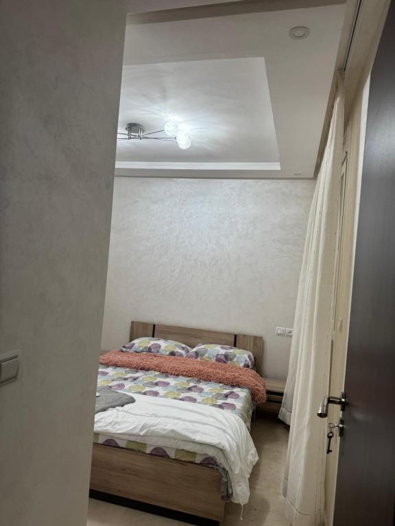 a bedroom with a bed in a small room at CHU Tanger in Tangier
