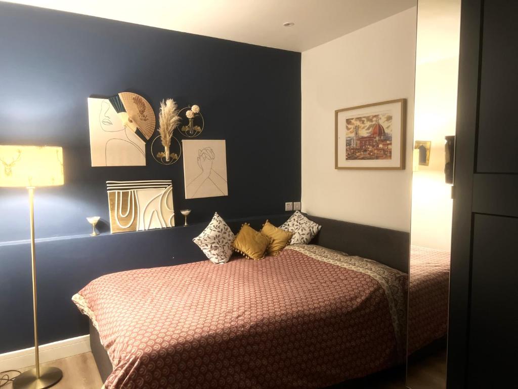 a bedroom with two beds and a blue wall at Double bed Studio in Finchley,North London in Finchley
