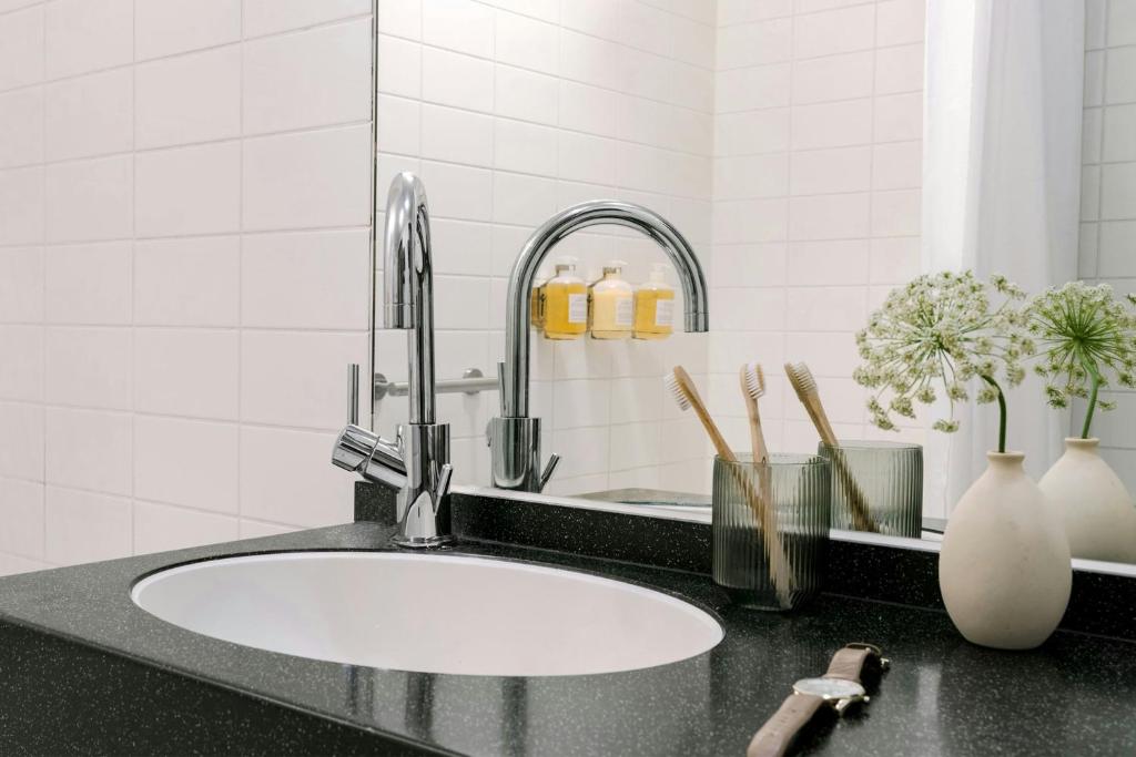a bathroom counter with a sink and a faucet at Park House Hotel Museum Quarter, Sonder by Marriott Bonvoy in Amsterdam