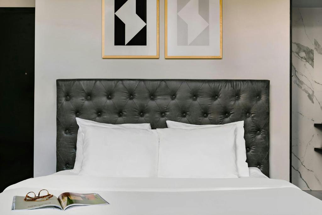 a bed with a black headboard and a book at Park House Hotel Museum Quarter, Sonder by Marriott Bonvoy in Amsterdam