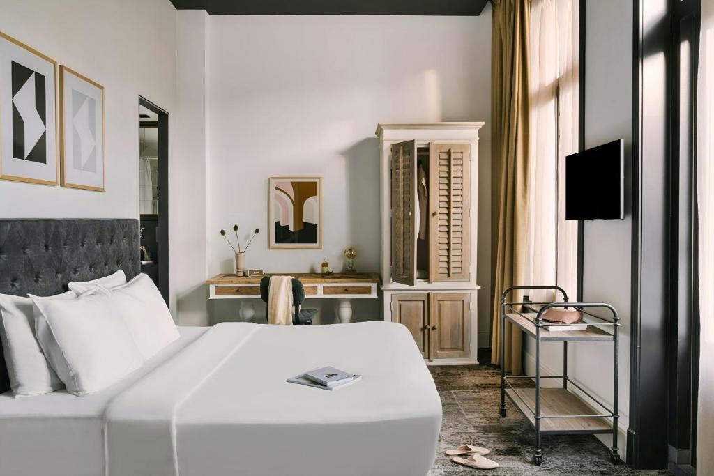a bedroom with a white bed and a television at Park House Hotel Museum Quarter, Sonder by Marriott Bonvoy in Amsterdam