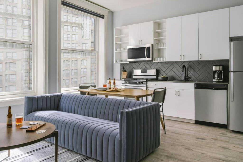 a living room with a couch and a kitchen at Sonder by Marriott Bonvoy The Plymouth Apartments Loop in Chicago