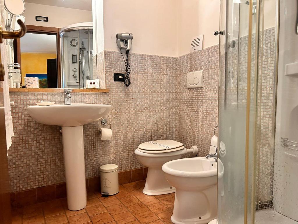 a bathroom with a sink and a toilet and a shower at Locanda Dei Baroni in Vasto