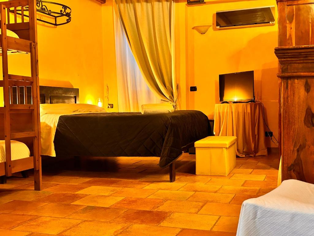 a bedroom with a bed and a television in it at Locanda Dei Baroni in Vasto