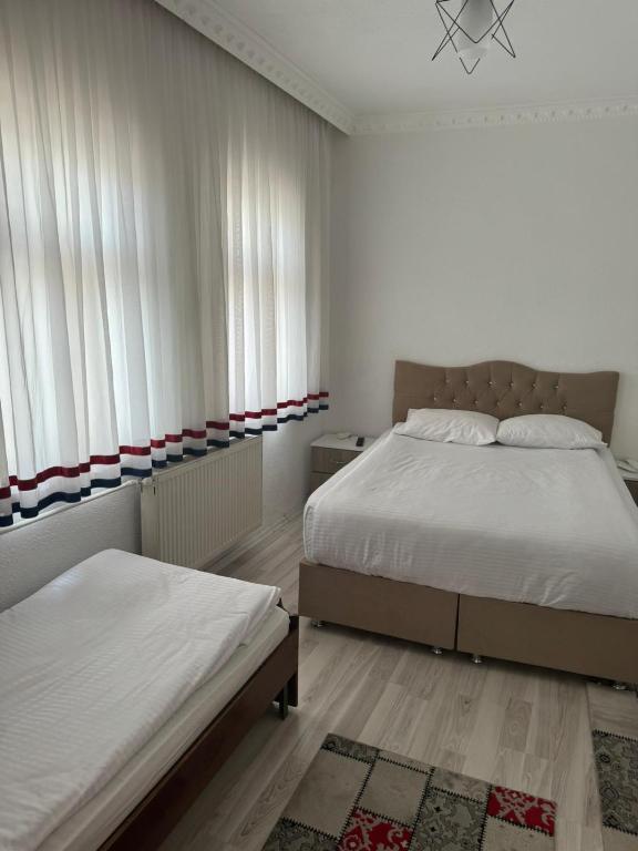 Postel nebo postele na pokoji v ubytování Gumus Hotel