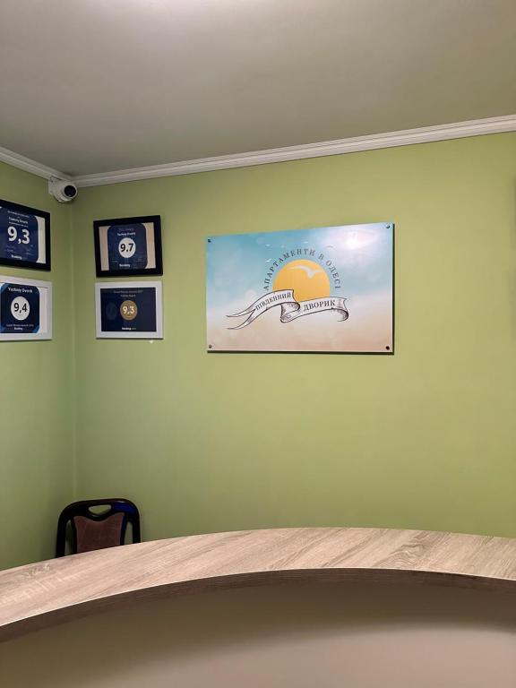 a wall with a picture on a green wall at Yuzhniy Dvorik in Odesa