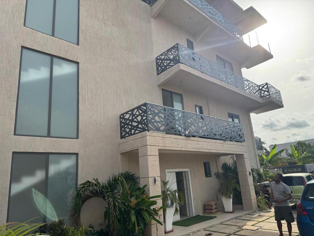 a man standing in front of a building at Premium Apartments in Santeo