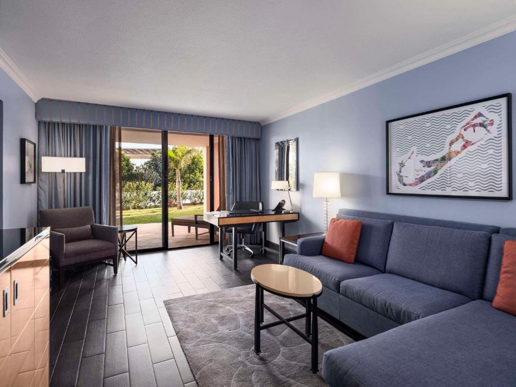 a living room with a couch and a table at Hamilton Princess & Beach Club A Fairmont Managed Hotel in Hamilton
