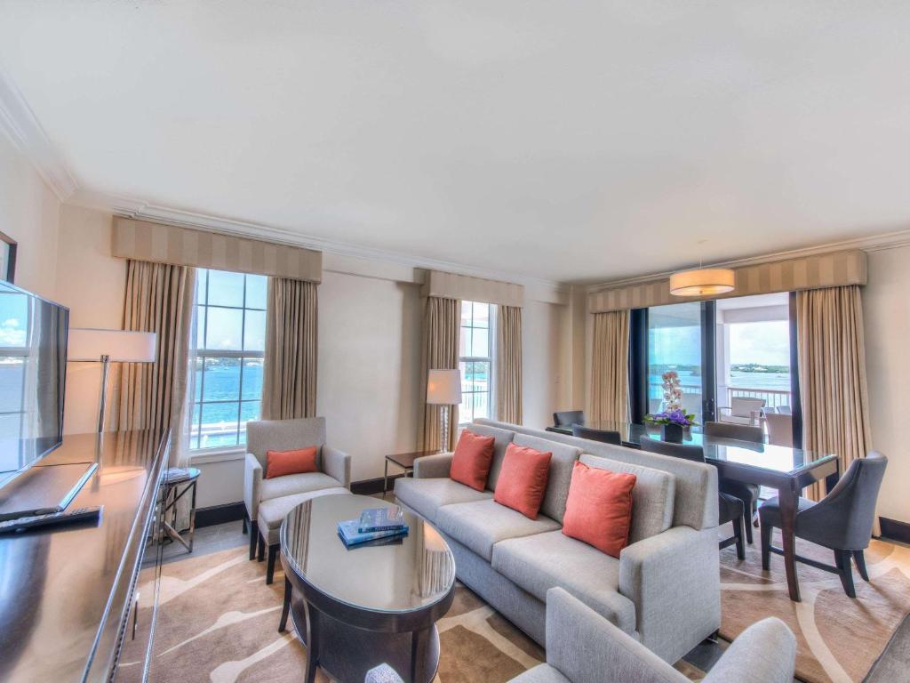a living room with a couch and a table at Hamilton Princess & Beach Club A Fairmont Managed Hotel in Hamilton
