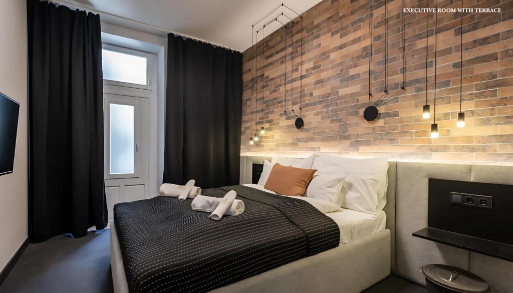 Postel nebo postele na pokoji v ubytování Váci Loft Suites