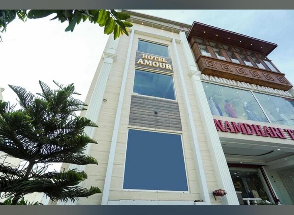 a building with a large sign on the side of it at Hotel AMOUR in Zirakpur