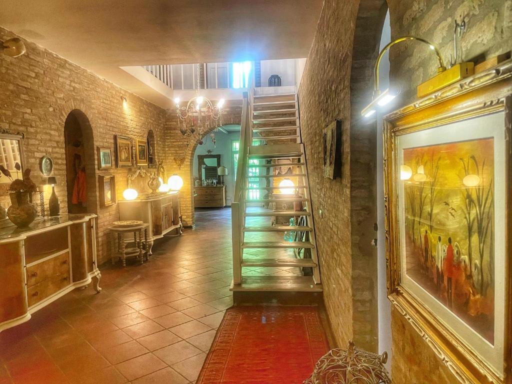 a hallway with a spiral staircase in a building at A Casa di Maica in Ferrara