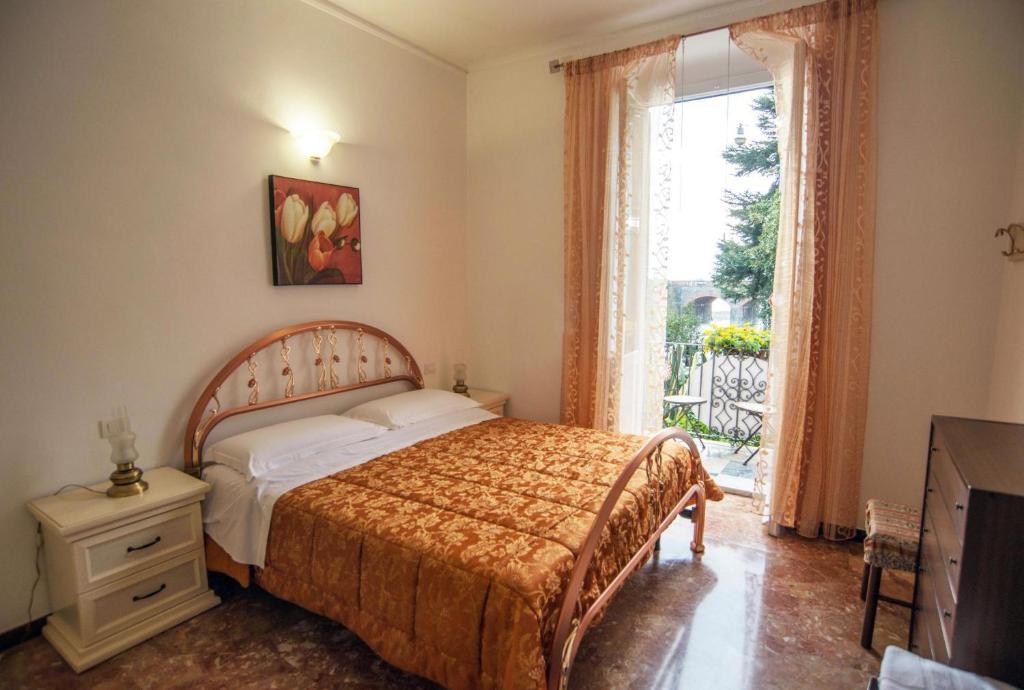 a bedroom with a bed and a large window at Affittacamere Agata Levanto in Levanto