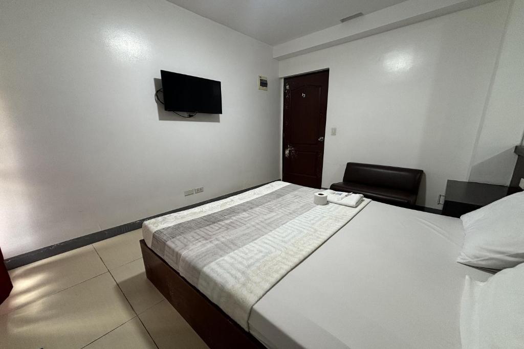 Postel nebo postele na pokoji v ubytování Yellowbell Hotel