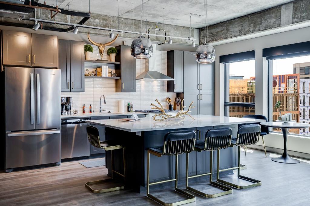 a kitchen with a large island with bar stools at Sable 501 - Luxury Two Story Loft in Minneapolis
