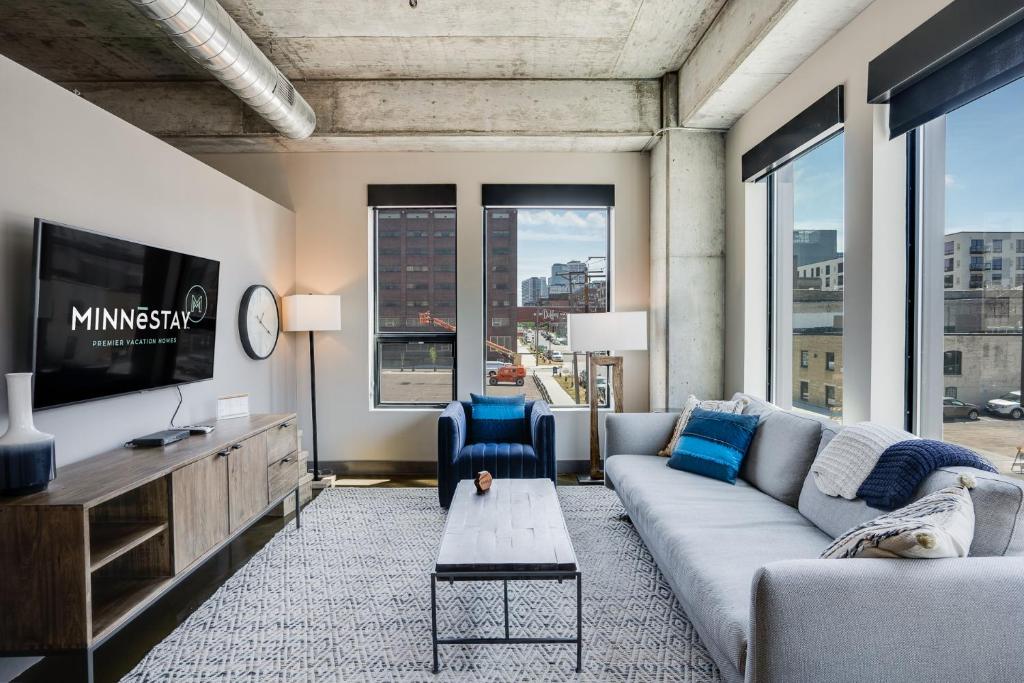 a living room with a couch and a tv at Sable 207 - One Bedroom in Minneapolis