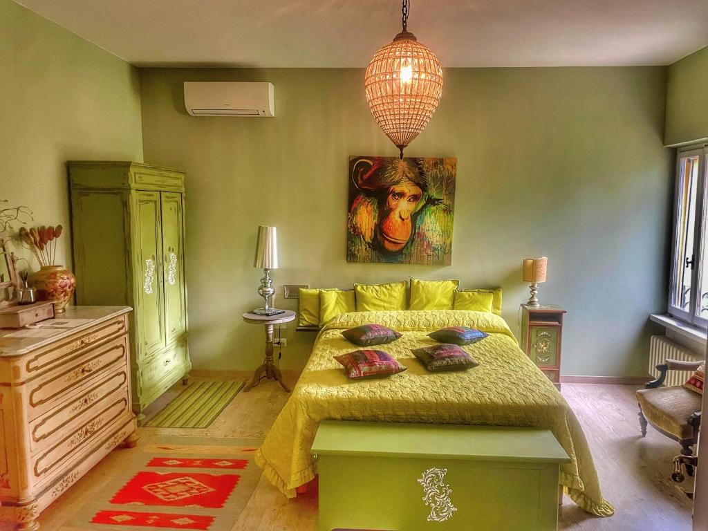 a bedroom with a bed and a painting on the wall at A Casa di Maica in Ferrara