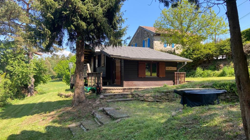 une cabane dans les bois avec une poubelle devant dans l'établissement Gîte du Lilas, à Mortagne