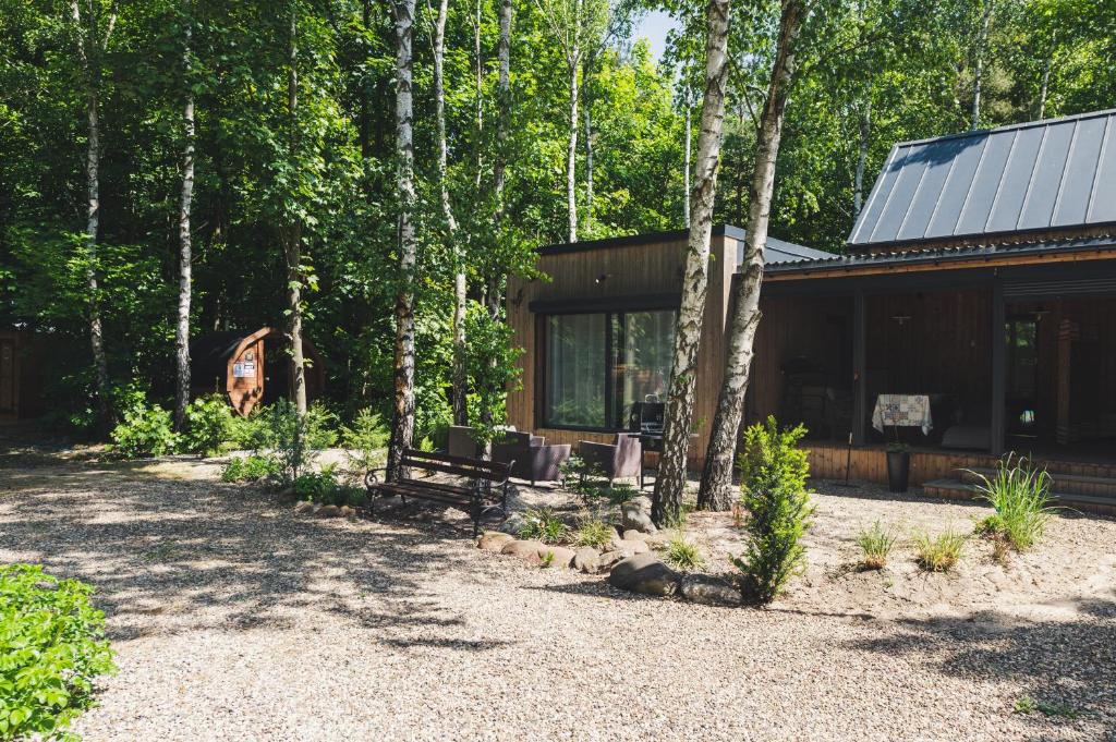 a cabin in the woods next to a forest at Apartament nad jeziorem Strykowskim in Sapowice