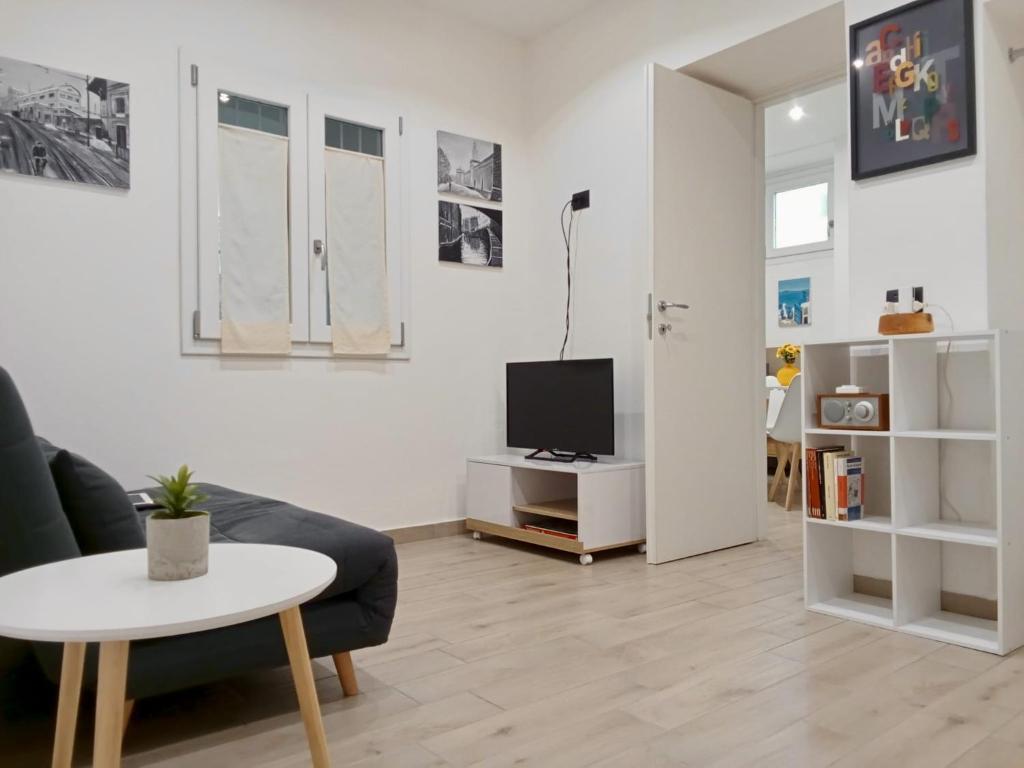a living room with a couch and a table and a tv at Casa Giannina in Germignaga