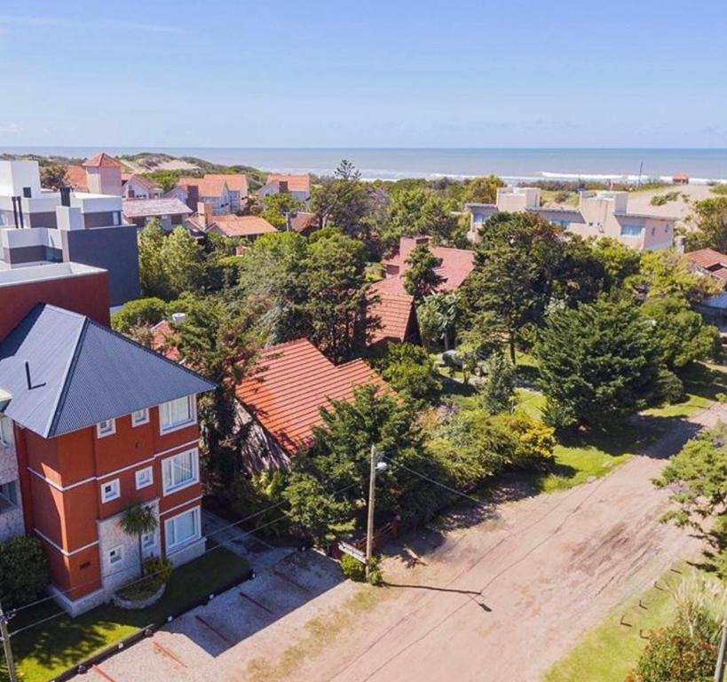 an aerial view of a residential neighborhood with a red house at Valeria Beach in Valeria del Mar