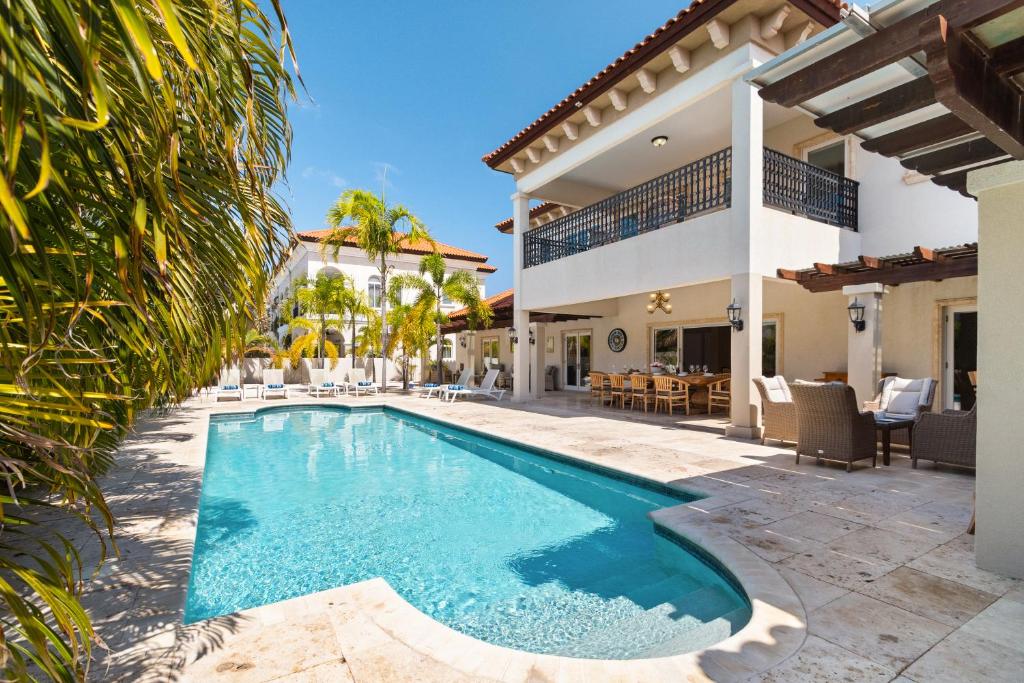 a swimming pool in the backyard of a house at Upscale Ocean View Villa with Pool Outdoor Kitchen in Palm-Eagle Beach