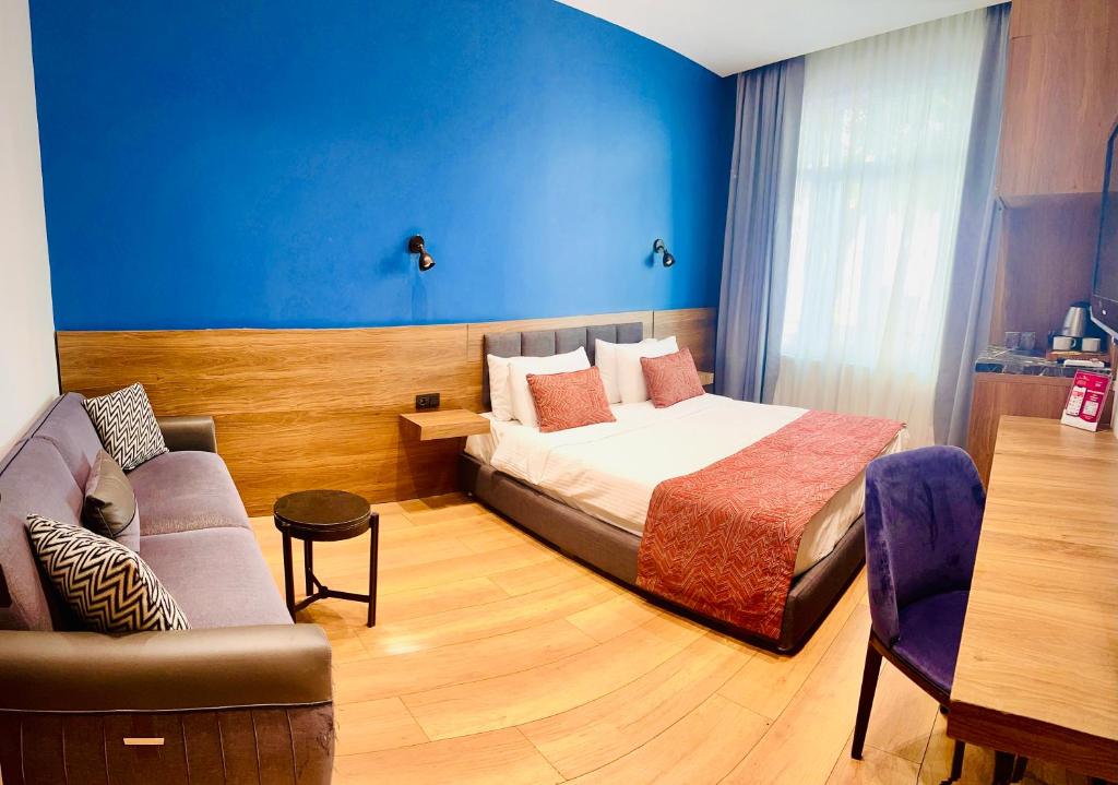 a hotel room with a bed and a couch at Beşiktaş Konuk Evi Hotel in Istanbul