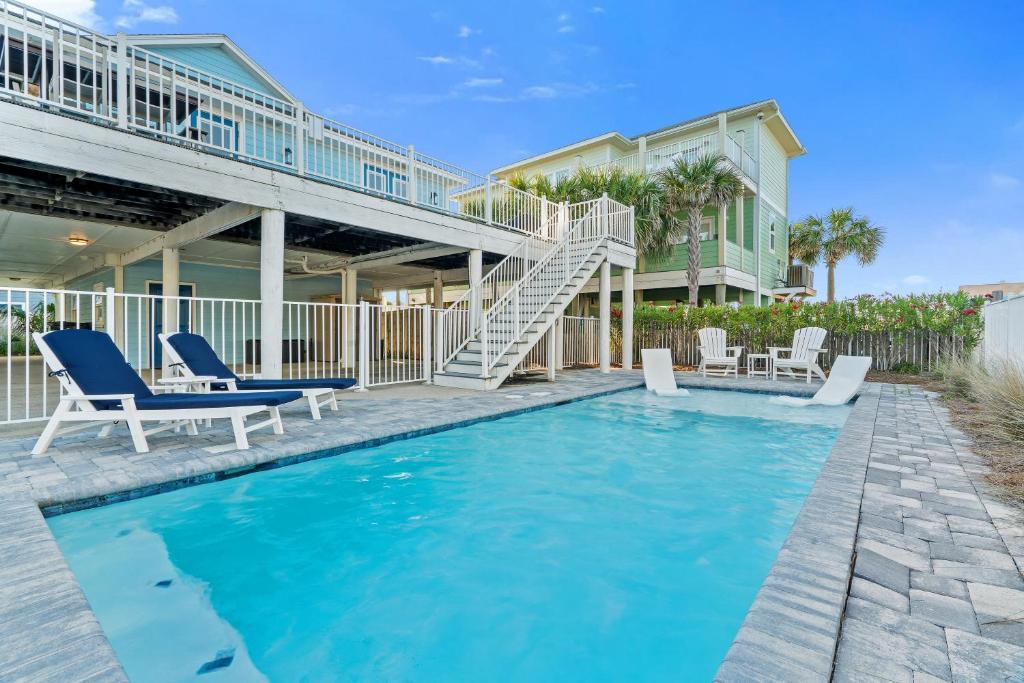a villa with a swimming pool and a house at Touch of Heaven in Pensacola Beach