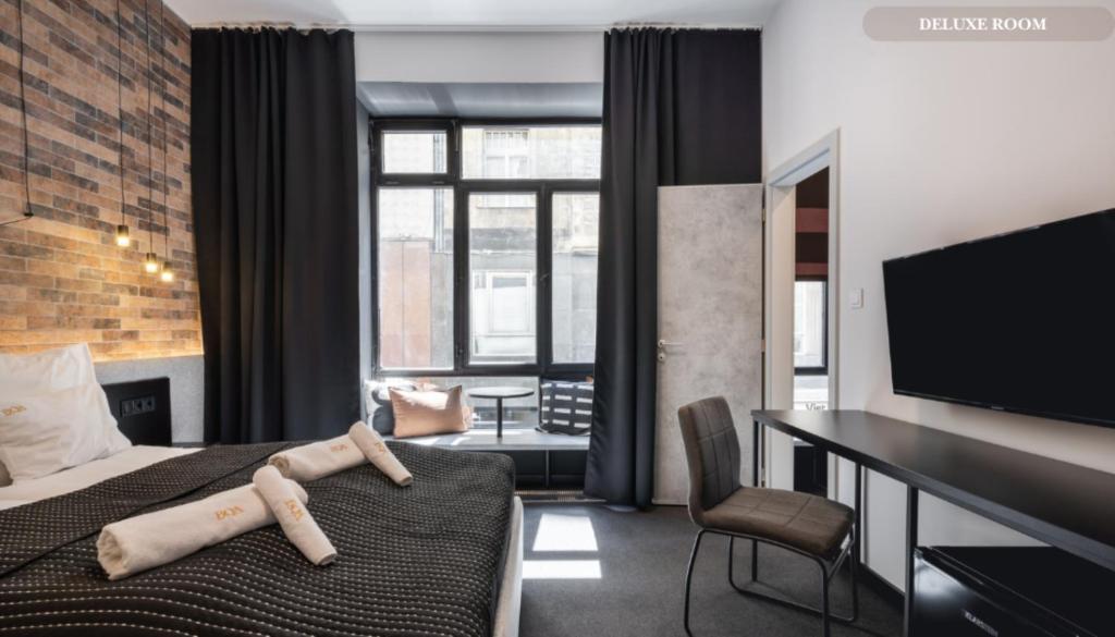 Postel nebo postele na pokoji v ubytování Váci Loft Suites