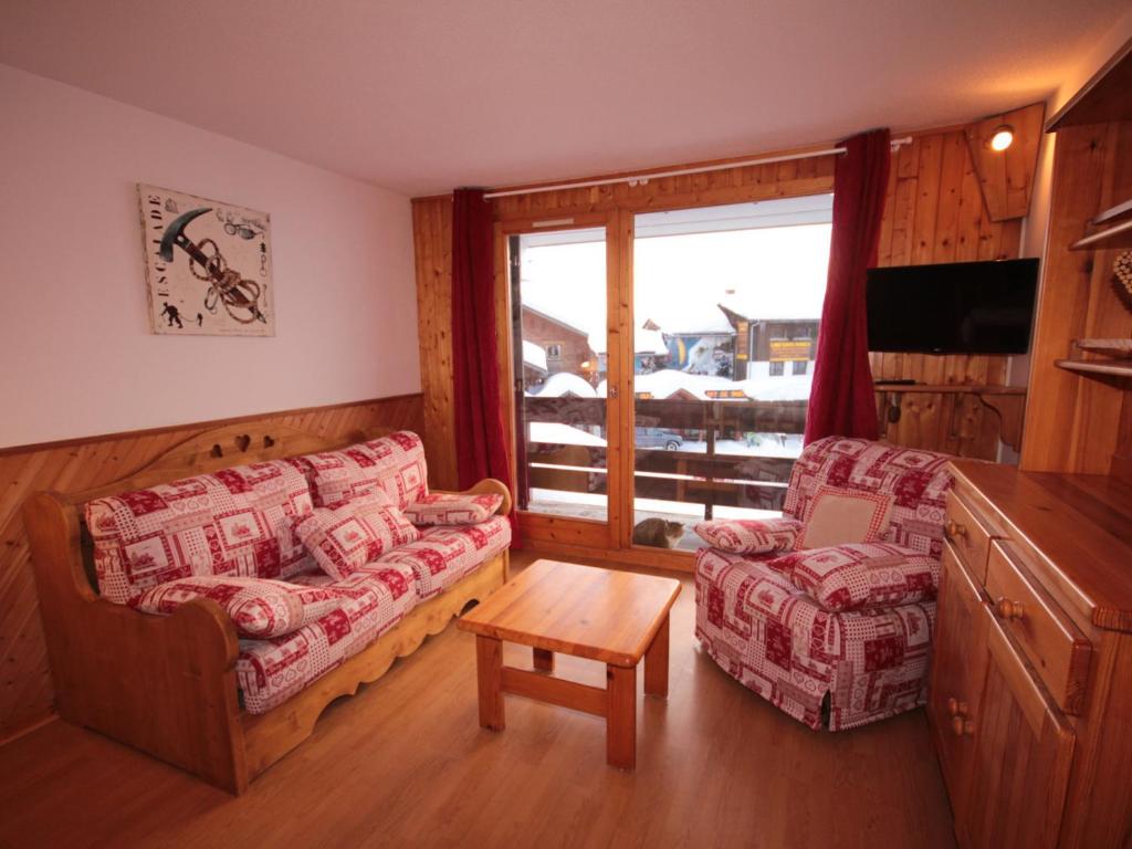 a living room with a couch and a chair and a window at Studio cabine lumineux avec balcon et vue, 4 pers, TV, Wi-Fi, Les Saisies - FR-1-293-142 in Les Saisies