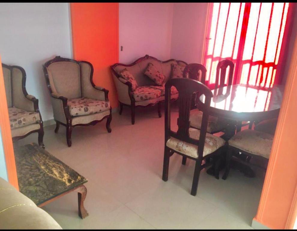 a room with chairs and a table and a table and chairs at Family holiday home beach view in Alexandria