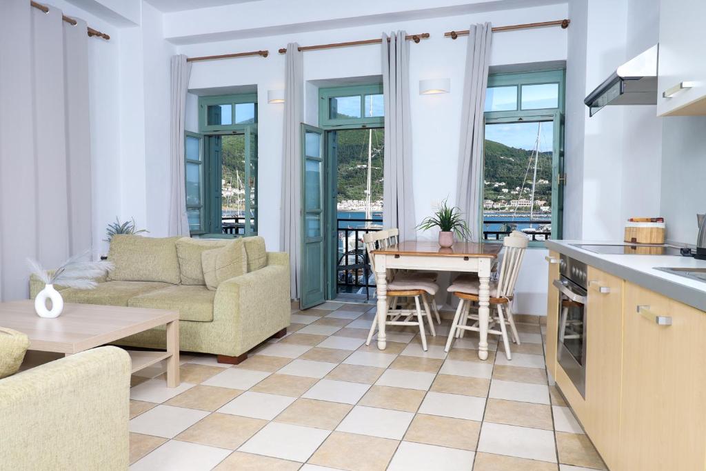 a kitchen and living room with a couch and a table at Faros Coastal Apartments in Skopelos Town