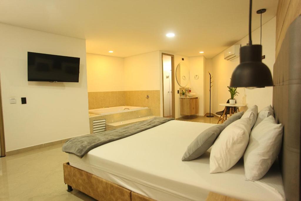 Postel nebo postele na pokoji v ubytování Hotel California Medellin