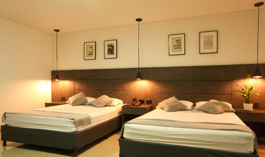 Postel nebo postele na pokoji v ubytování Hotel California Medellin
