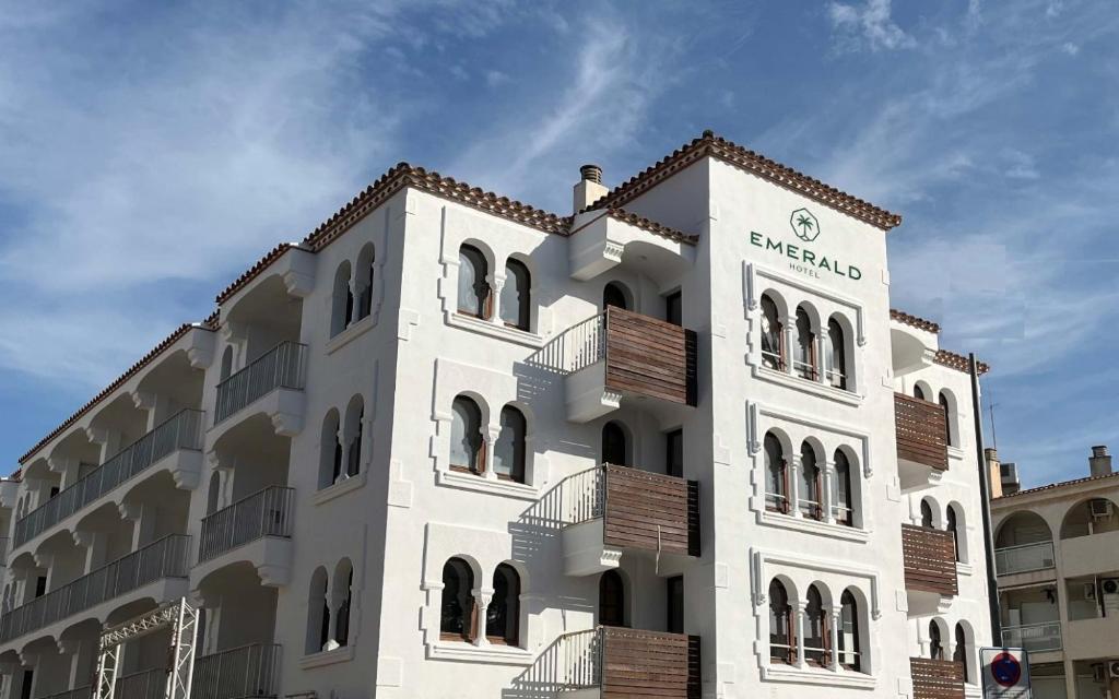a large white building with a sign on it at Emerald Sun Hotel in Cambrils