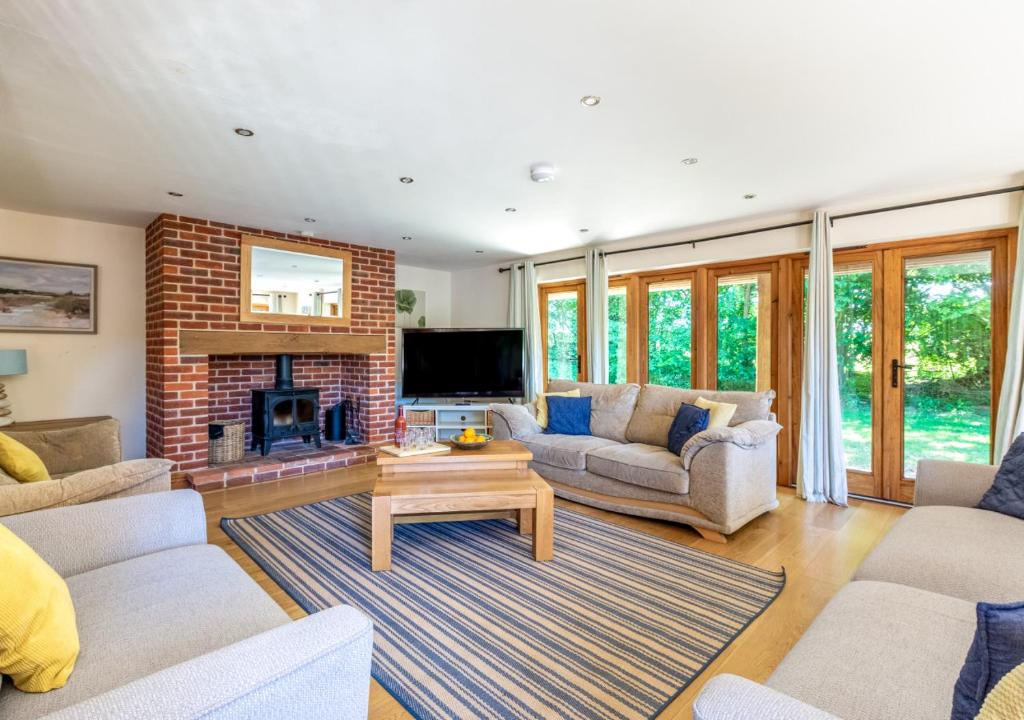サーズフォードにあるFoden Lodgeの2つのソファと暖炉のあるリビングルーム