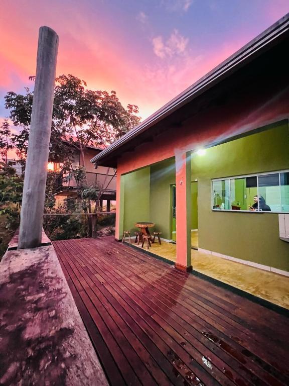a house with a wooden deck at sunset at Casa do Chagas in Sao Jorge