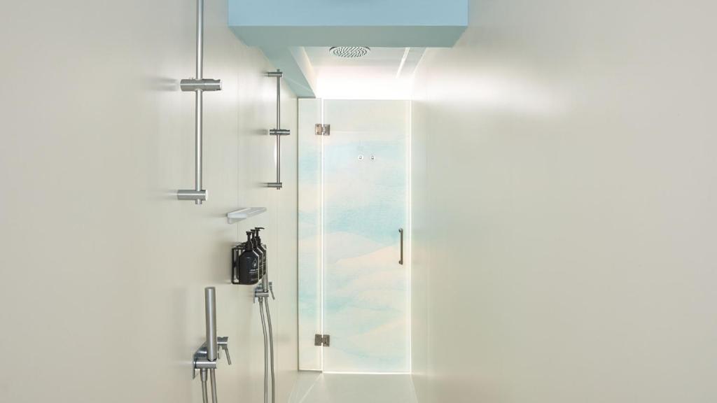 a shower with a glass door in a bathroom at Hotel Indigo Albufeira by IHG in Albufeira