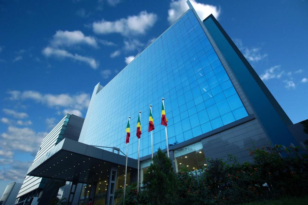 un edificio con banderas en el frente en GHS Hotel, en Brazzaville
