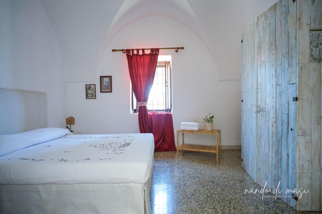 a bedroom with a bed and a window at Masseria Giangrande - Rooms and Apartment in Polignano a Mare