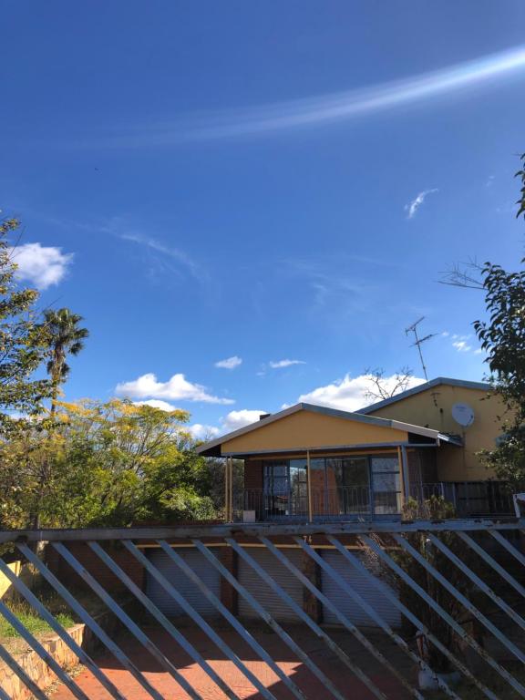 ein Haus mit einem Zaun davor in der Unterkunft Michelle Cottage in Southgate