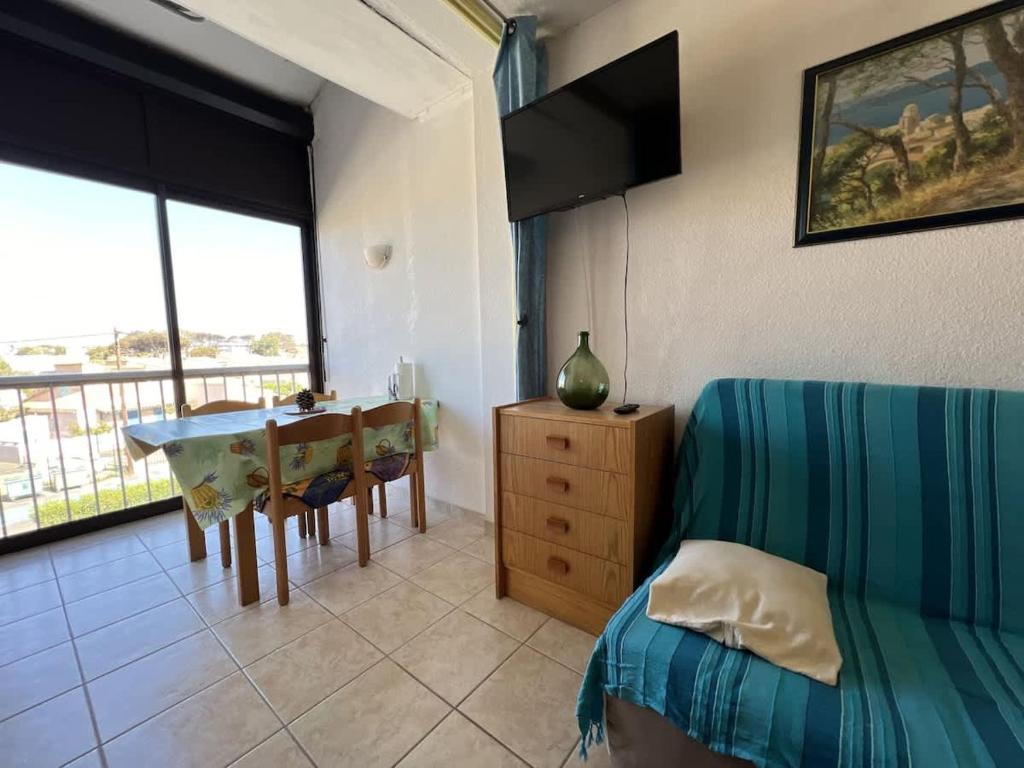 - une chambre avec une table et un lit ainsi qu'une salle à manger dans l'établissement Appartement, à Valras-Plage