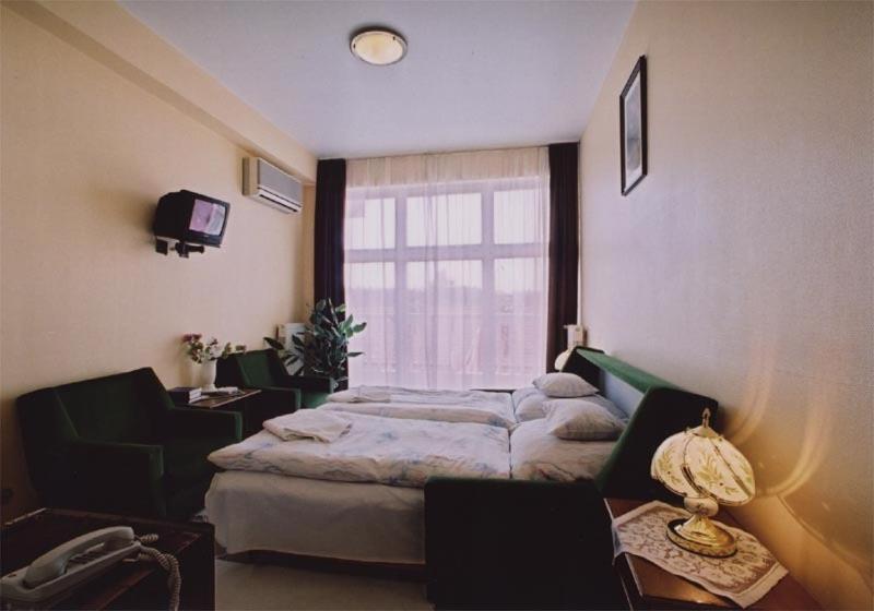 Postel nebo postele na pokoji v ubytování Hotel Uno