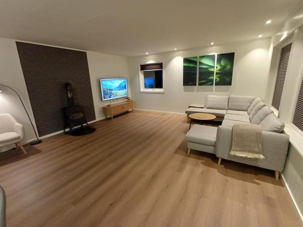 a living room with a couch and a tv at Private 4 bedroom getaway in Lofoten in Vestvågøya